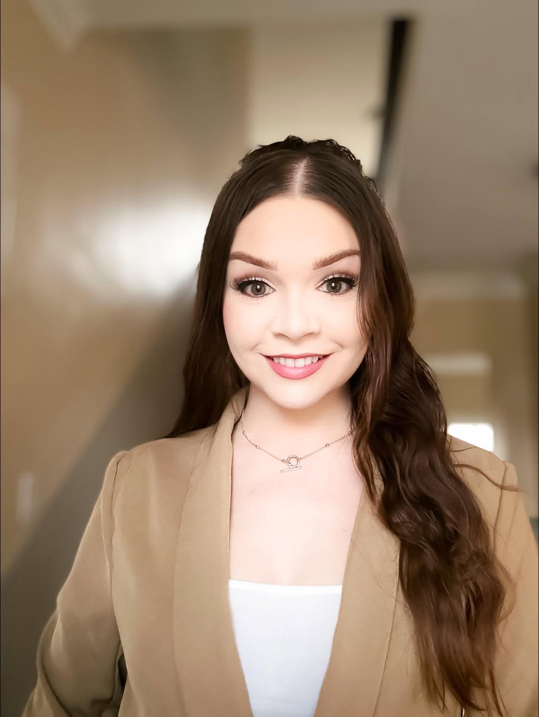 Bright Smiling Woman With Long Brown Hair, Professional Look, In An Office Setting.