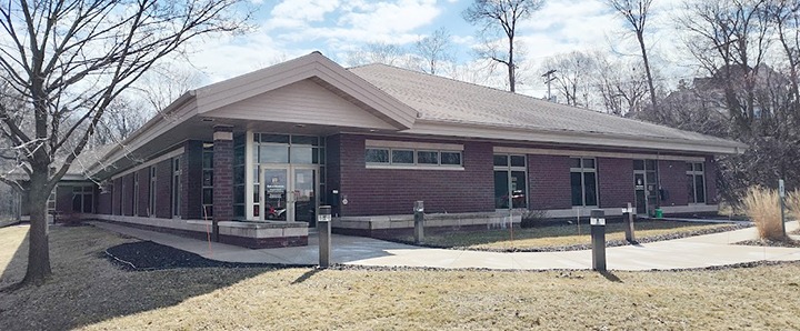 Modern Corporate Office Building With Brick Facade And Large Windows, Representing Crescendo Consulting.