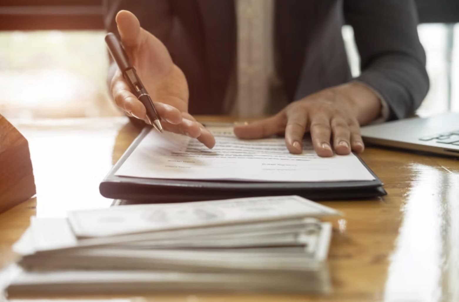 Professional Business Consultation With Documents And Laptop On Wooden Desk.