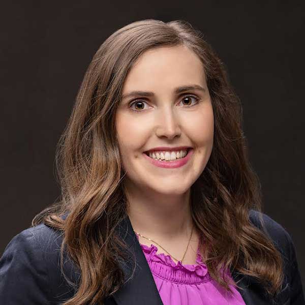 Experienced Business Consultant Smiling, Professional Woman In Formal Attire Representing Crescendo Consulting.